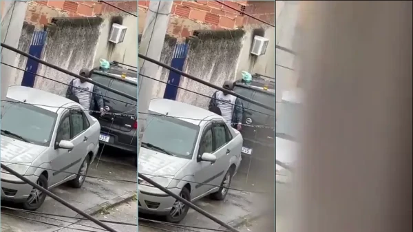 Nesse vídeo, a menina faz um trabalho diferente com o rapaz ali na calçada, atrás de um carro